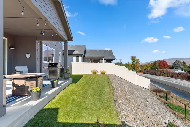 a swimming pool with outdoor seating and yard
