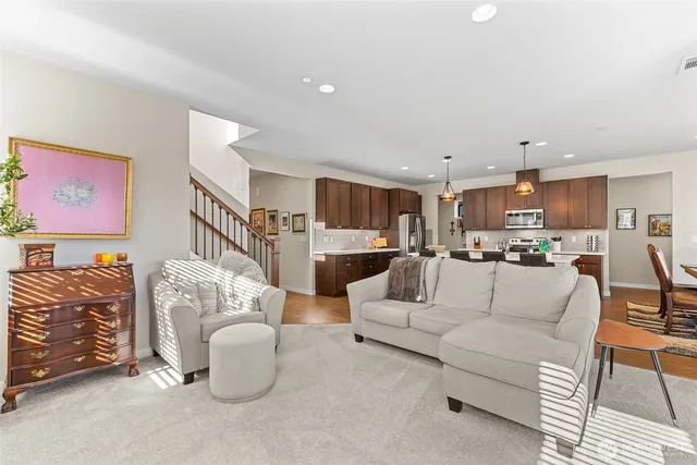 a living room with furniture kitchen view and a table