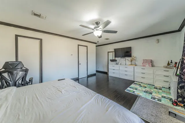 a bedroom with furniture and a flat screen tv