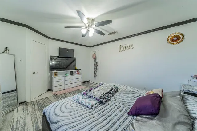 a bedroom with a bed and a flat screen tv