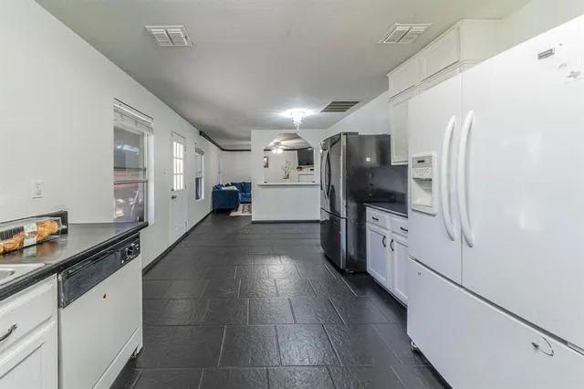 a kitchen with stainless steel appliances a refrigerator and a stove