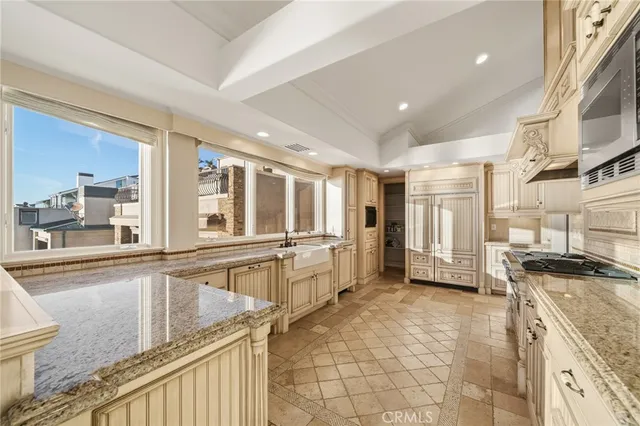 a bedroom with a bed and large windows