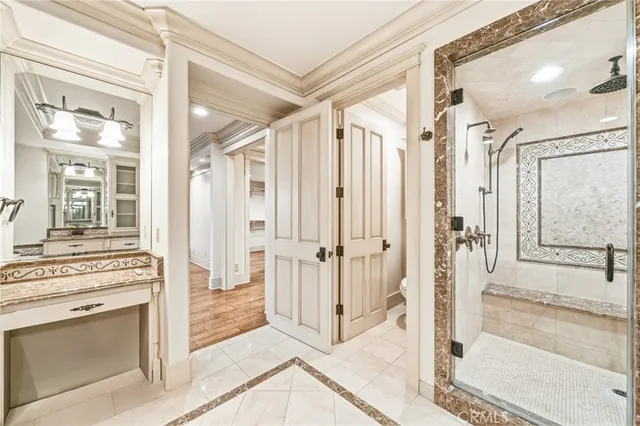 a bathroom with a granite countertop sink toilet a mirror and a tub