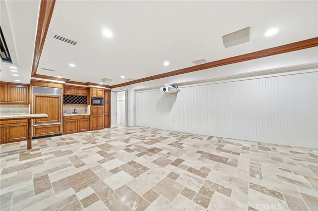 a view of a big room with wooden floor and windows