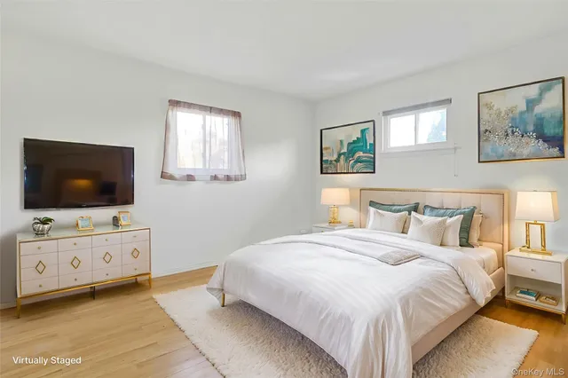 a bedroom with a flat screen tv and a dresser