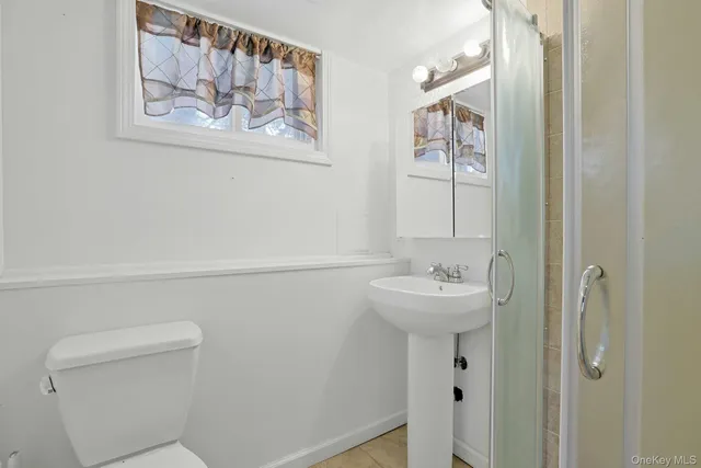 a bathroom with a sink a mirror and a toilet