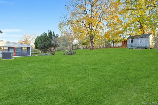 a backyard of a house with table and chairs