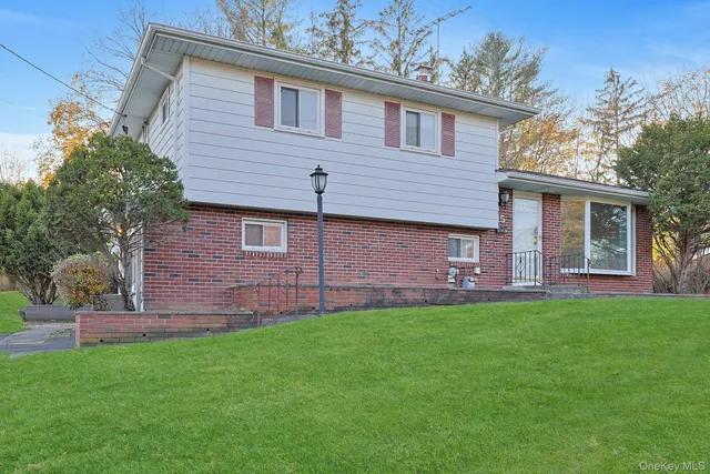a front view of a house with a garden