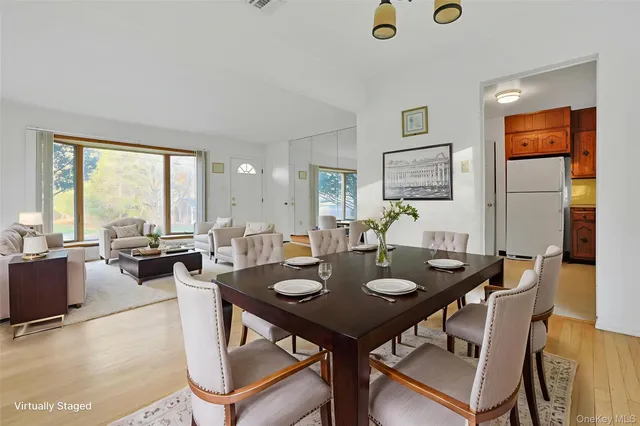 a view of a dining room with furniture and window