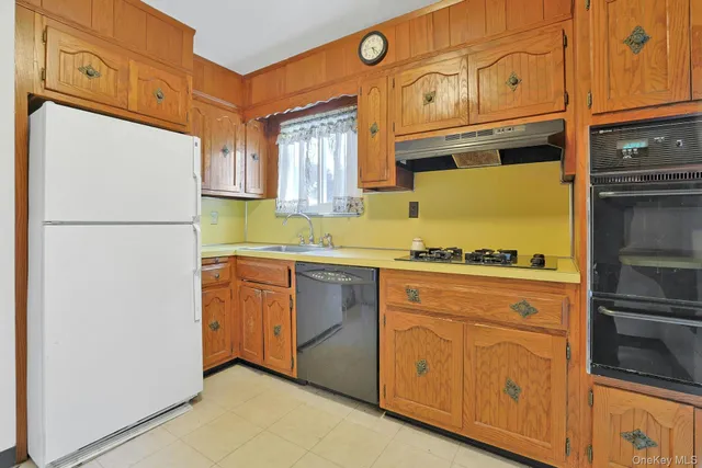 a kitchen with granite countertop cabinets stainless steel appliances and a counter space
