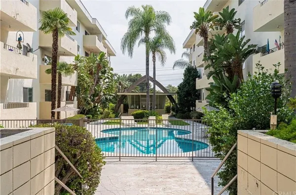 a view of house with outdoor space and swimming pool