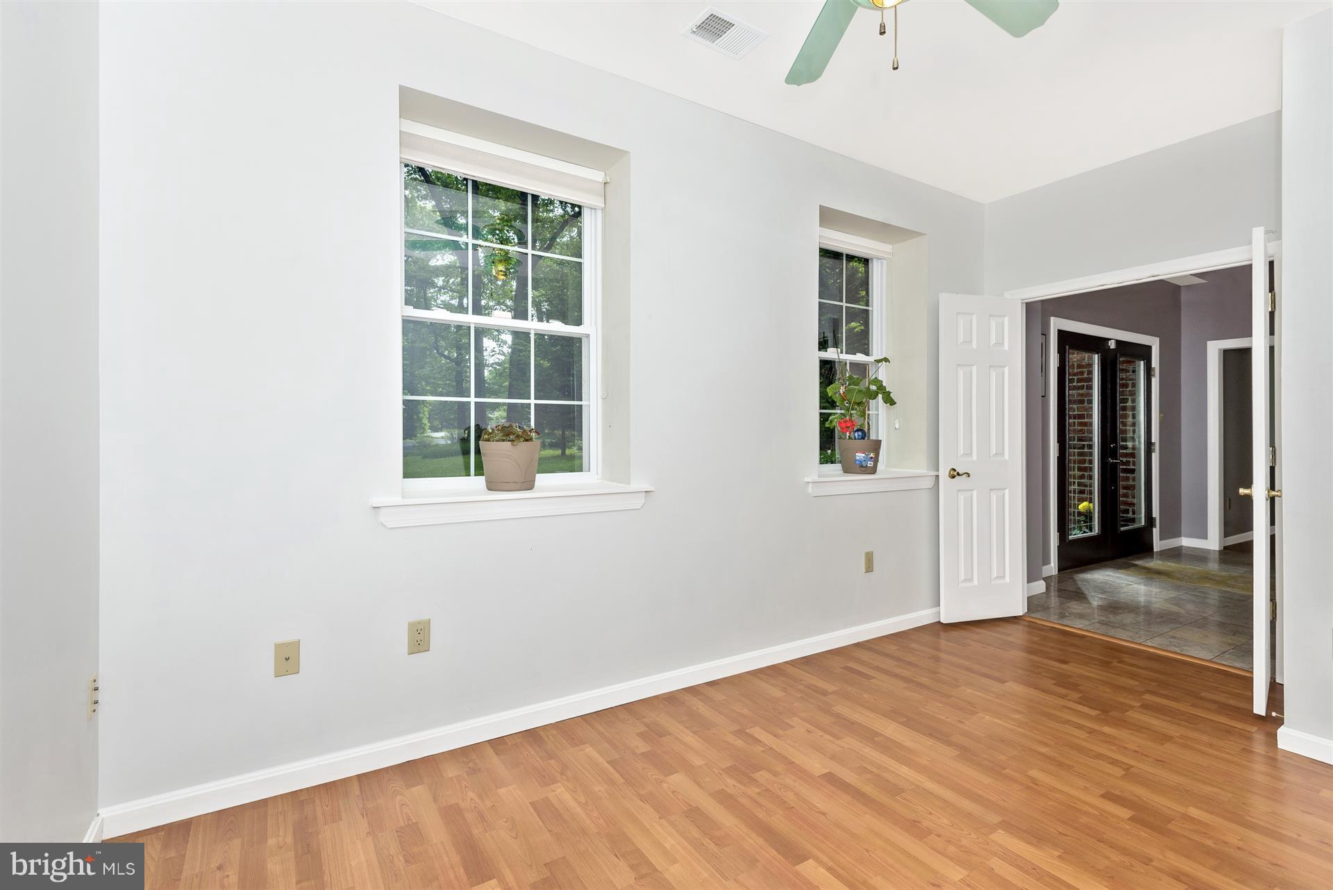 14435 Unionville Road Mount Airy, MD 21771 - Photo 11 of 28 an empty room with wooden floor and windows