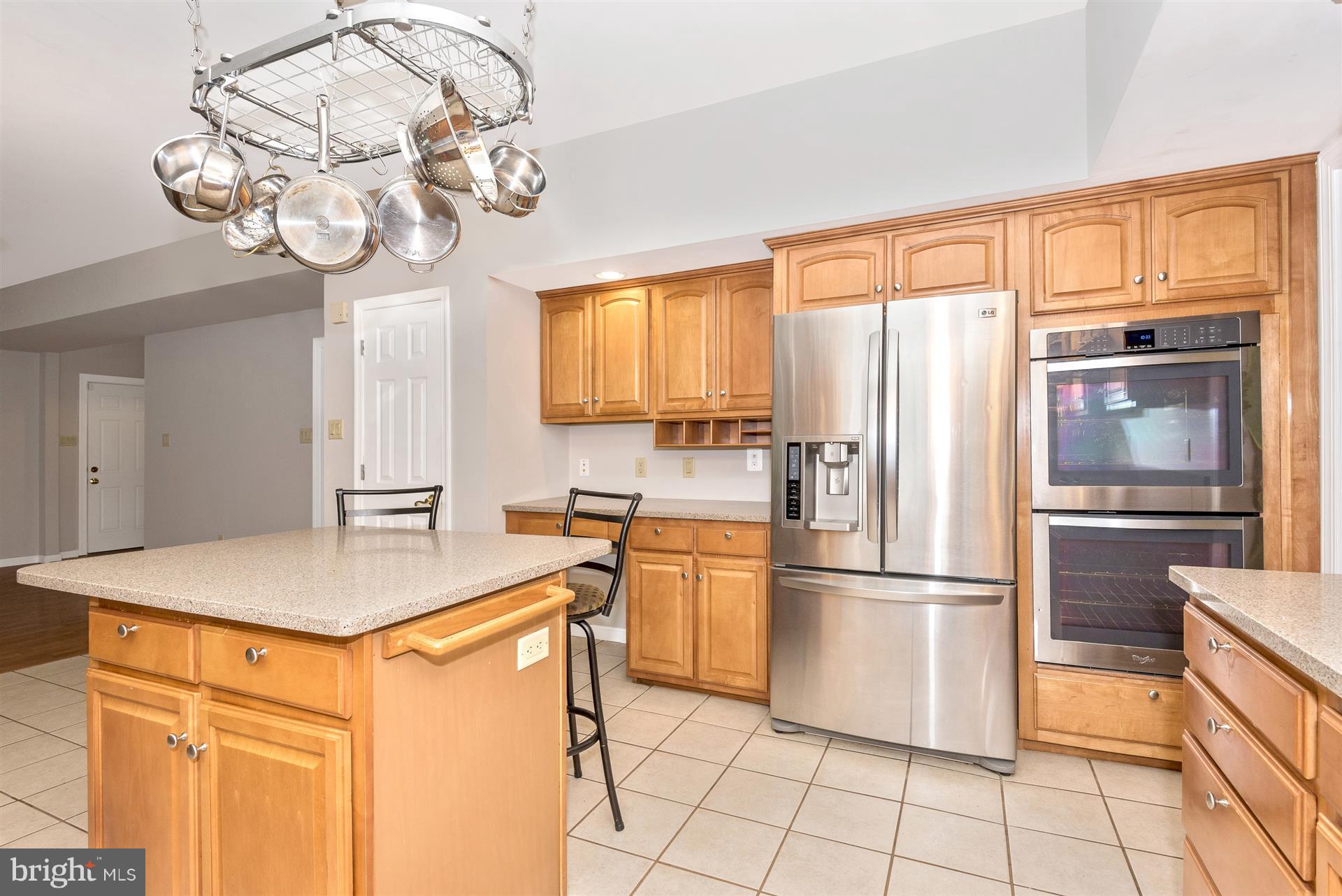 14435 Unionville Road Mount Airy, MD 21771 - Photo 14 of 28 a kitchen with stainless steel appliances granite countertop a refrigerator a sink dishwasher and a dining table with wooden floor