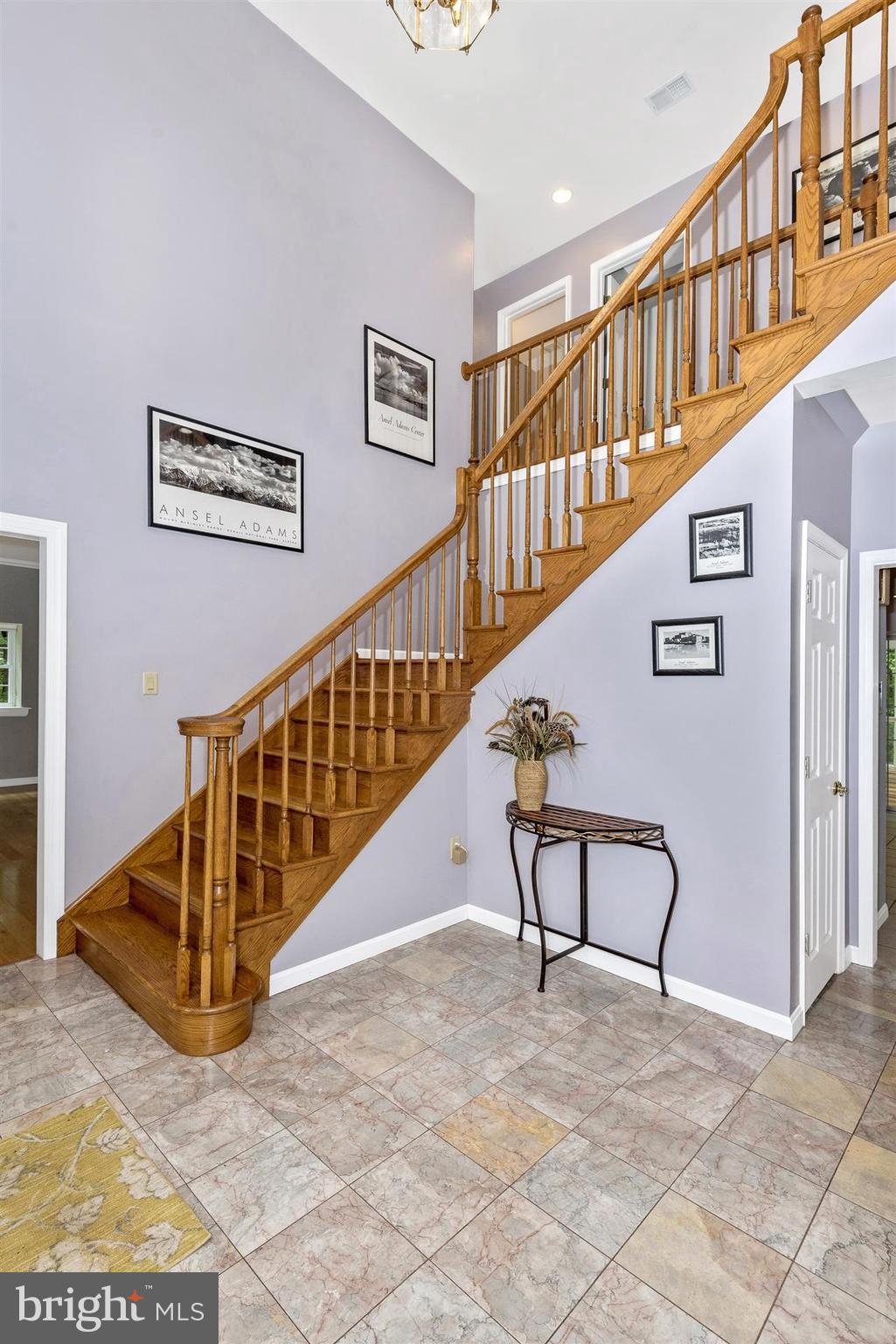 14435 Unionville Road Mount Airy, MD 21771 - Photo 18 of 28 a view of staircase with lots of frames and frames on a table