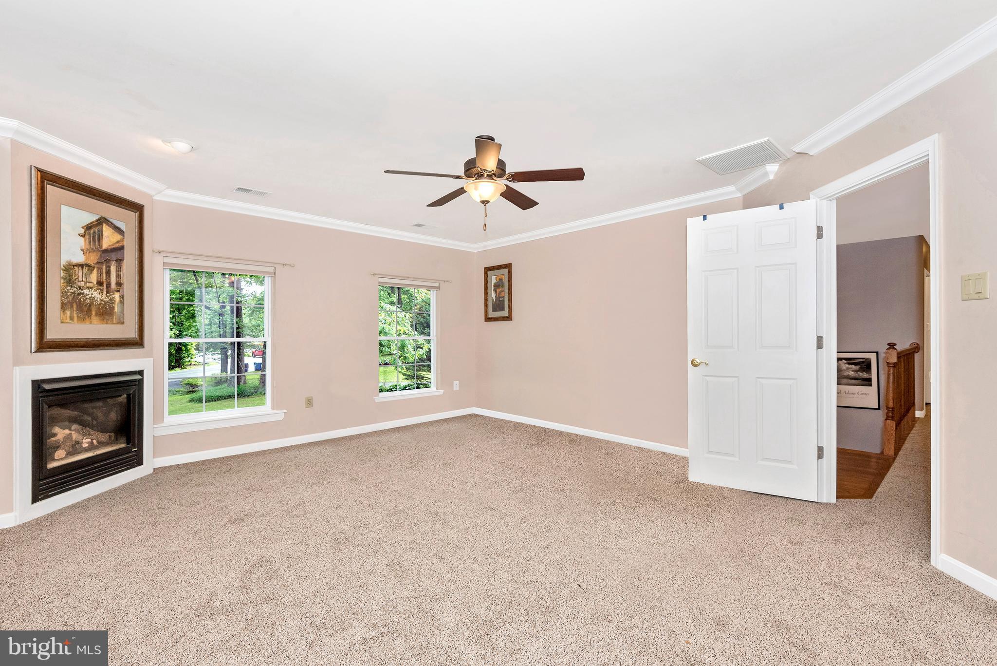 14435 Unionville Road Mount Airy, MD 21771 - Photo 20 of 28 a view of a livingroom with a fireplace and a chandelier fan