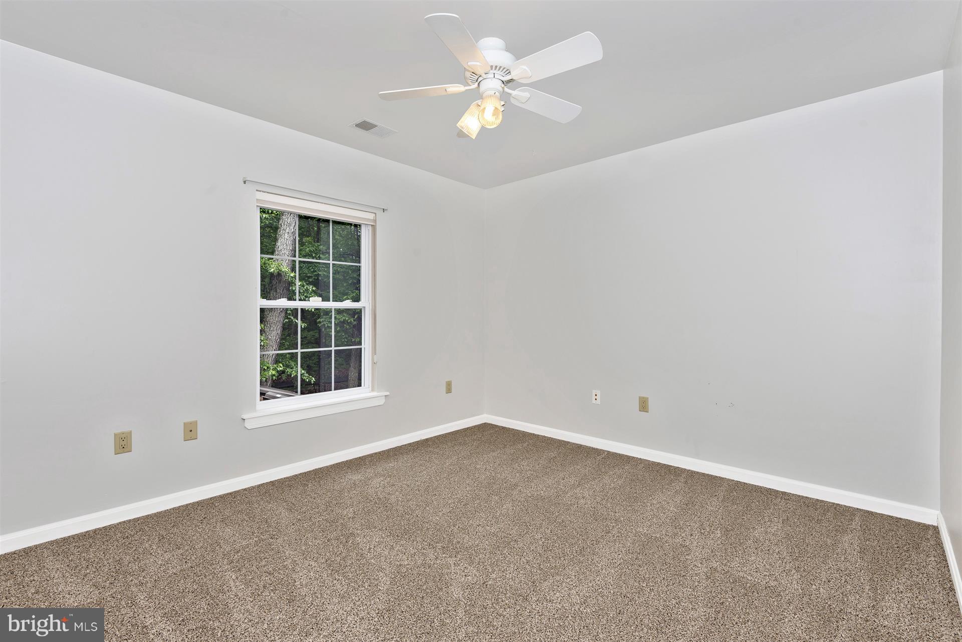 14435 Unionville Road Mount Airy, MD 21771 - Photo 27 of 28 an empty room with a window and a fan