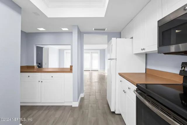 a kitchen with a refrigerator and a sink