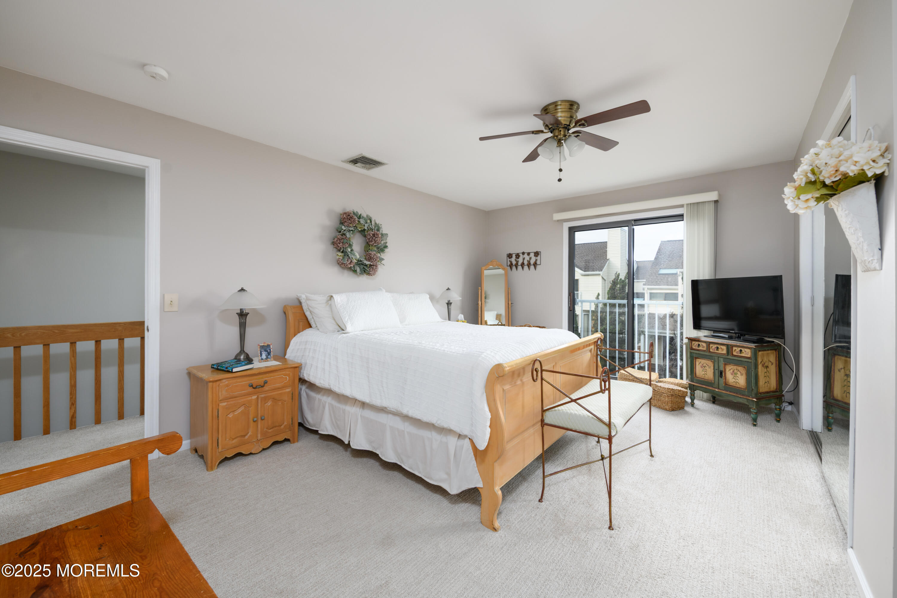 580 Patten Avenue, Unit 31 Long Branch, NJ 07740 - Photo 12 of 30 a bedroom with a bed a flat screen tv and a couch