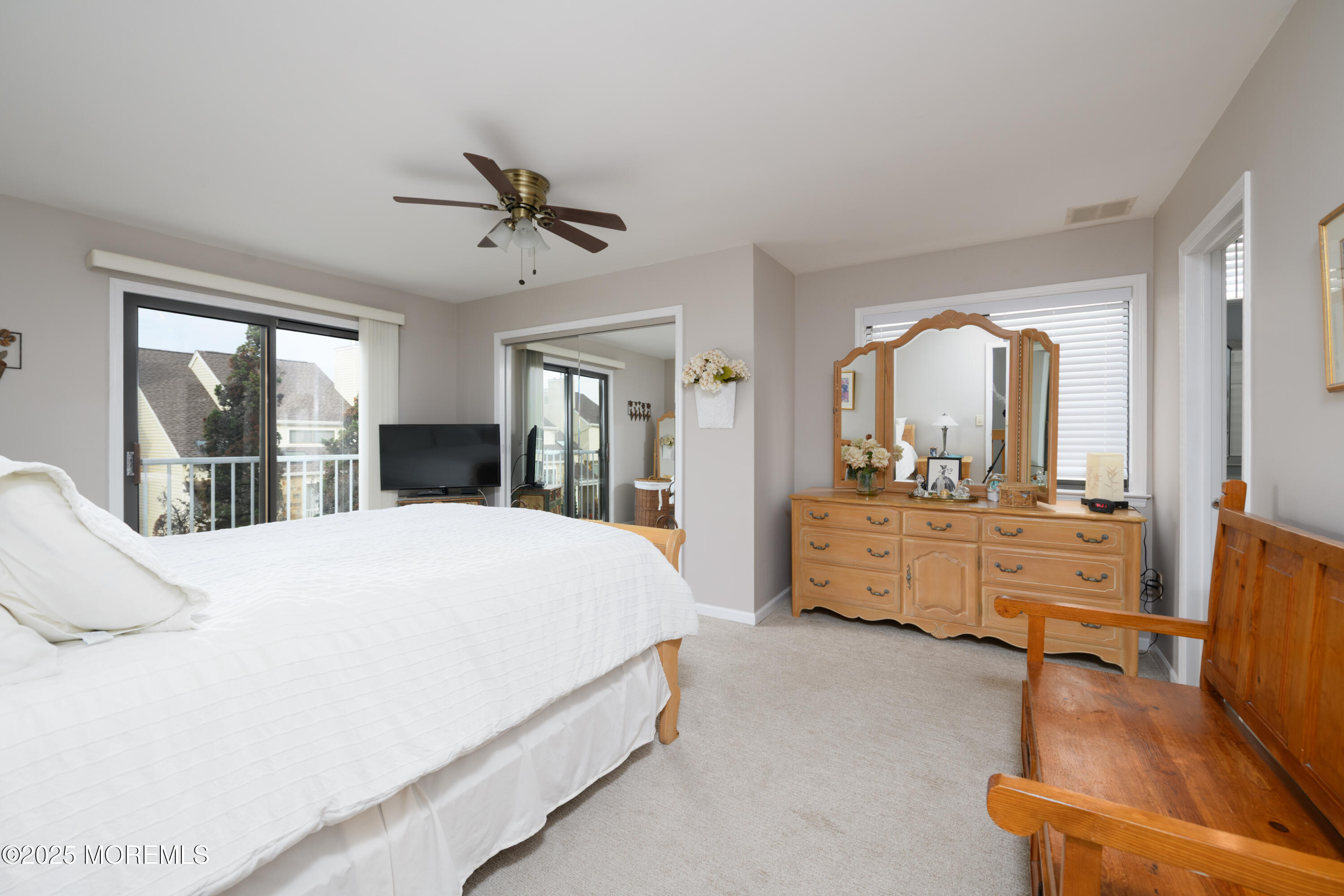 580 Patten Avenue, Unit 31 Long Branch, NJ 07740 - Photo 13 of 30 a bedroom with a large bed and wooden floor
