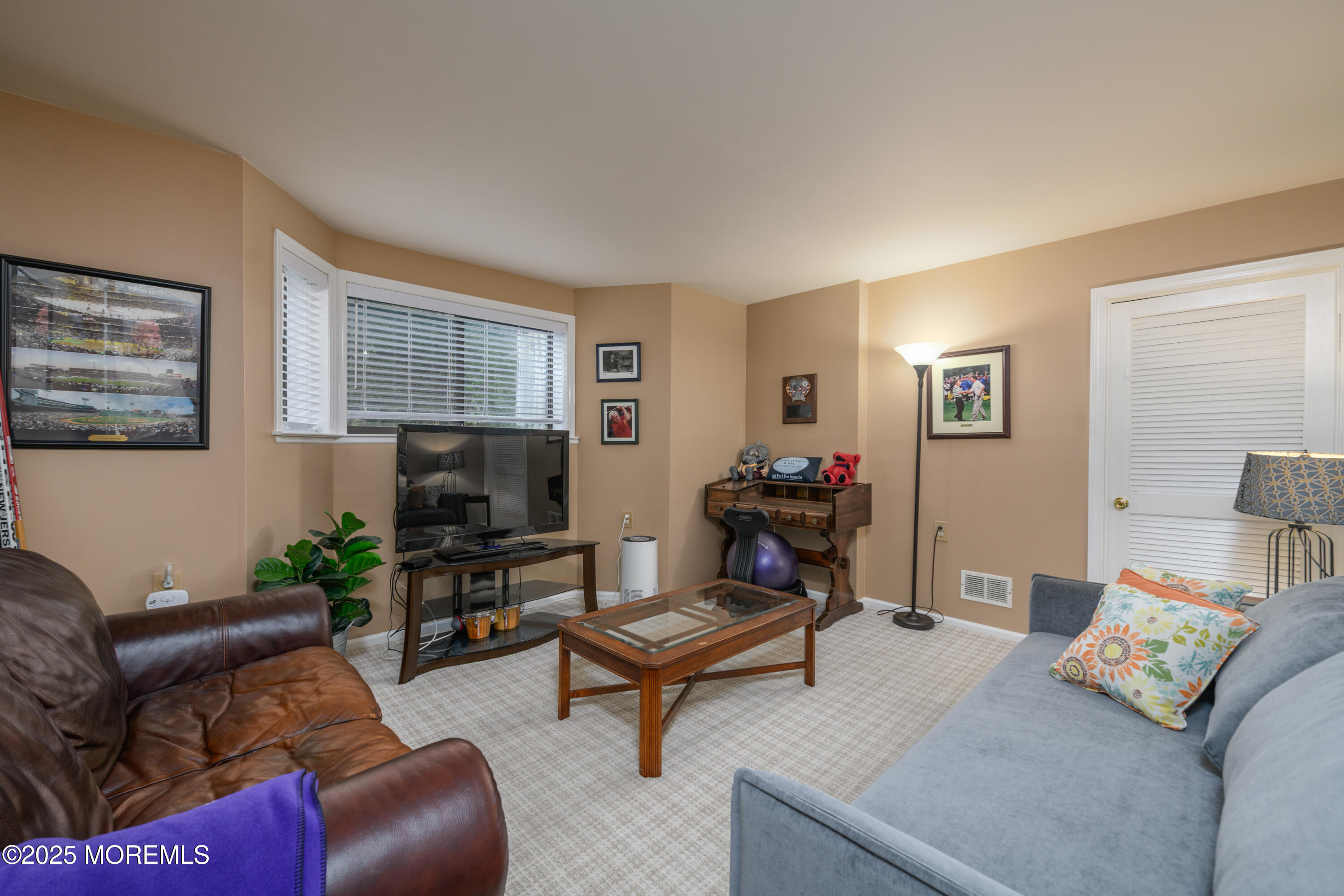 580 Patten Avenue, Unit 31 Long Branch, NJ 07740 - Photo 23 of 30 a living room with furniture and a flat screen tv