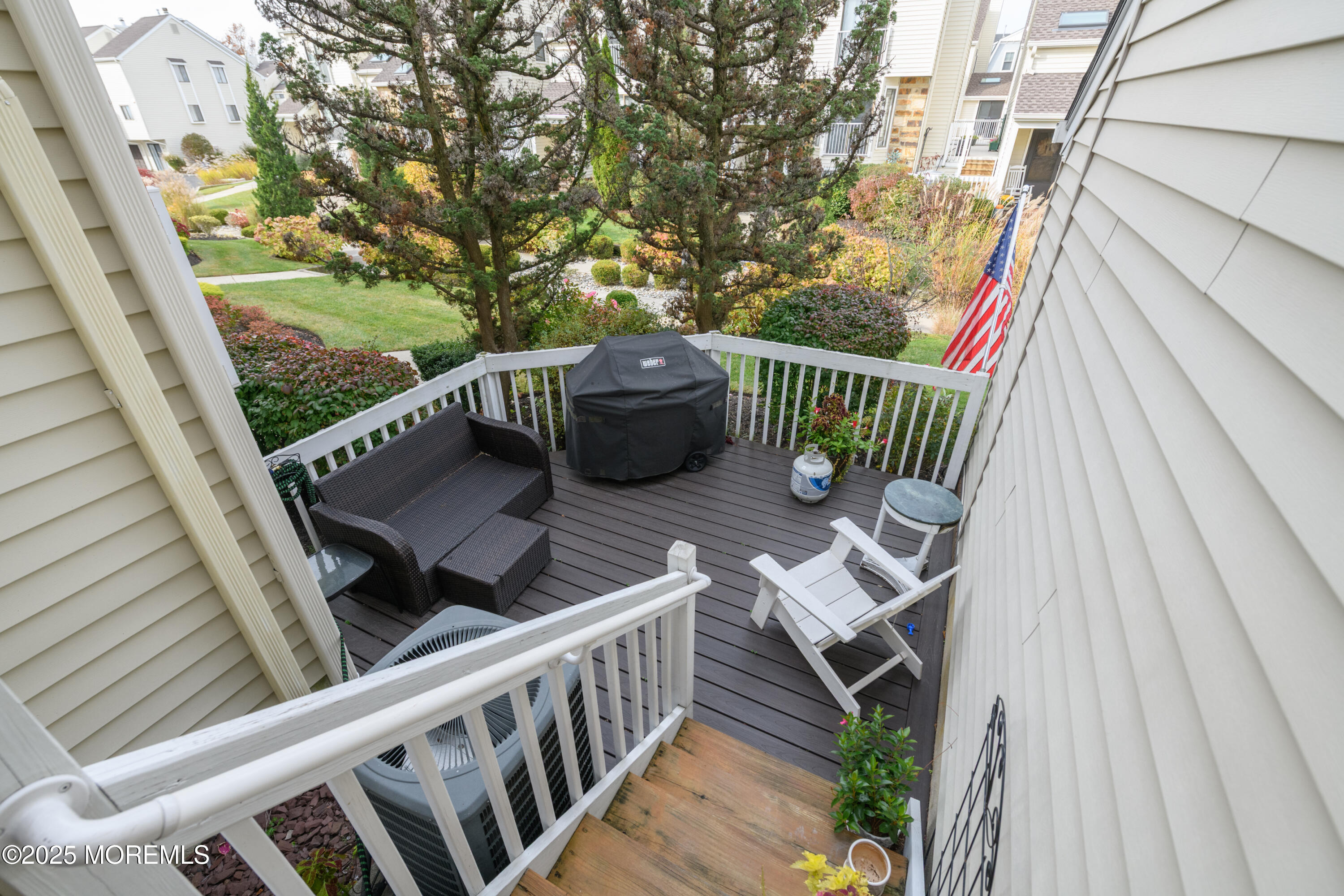 580 Patten Avenue, Unit 31 Long Branch, NJ 07740 - Photo 25 of 30 a view of a deck with two chairs and a table