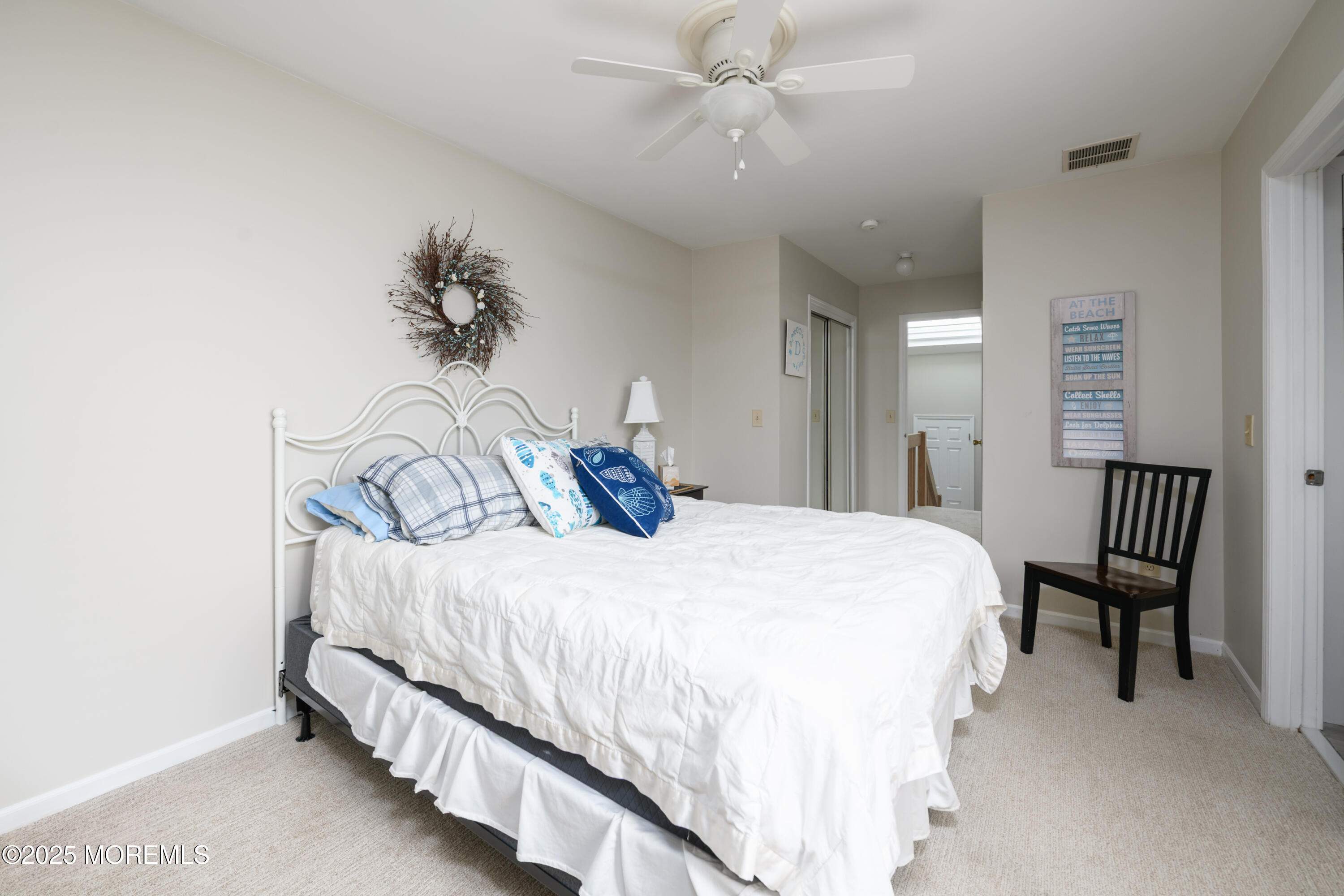 580 Patten Avenue, Unit 31 Long Branch, NJ 07740 - Photo 27 of 30 a bedroom with a bed and a chandelier