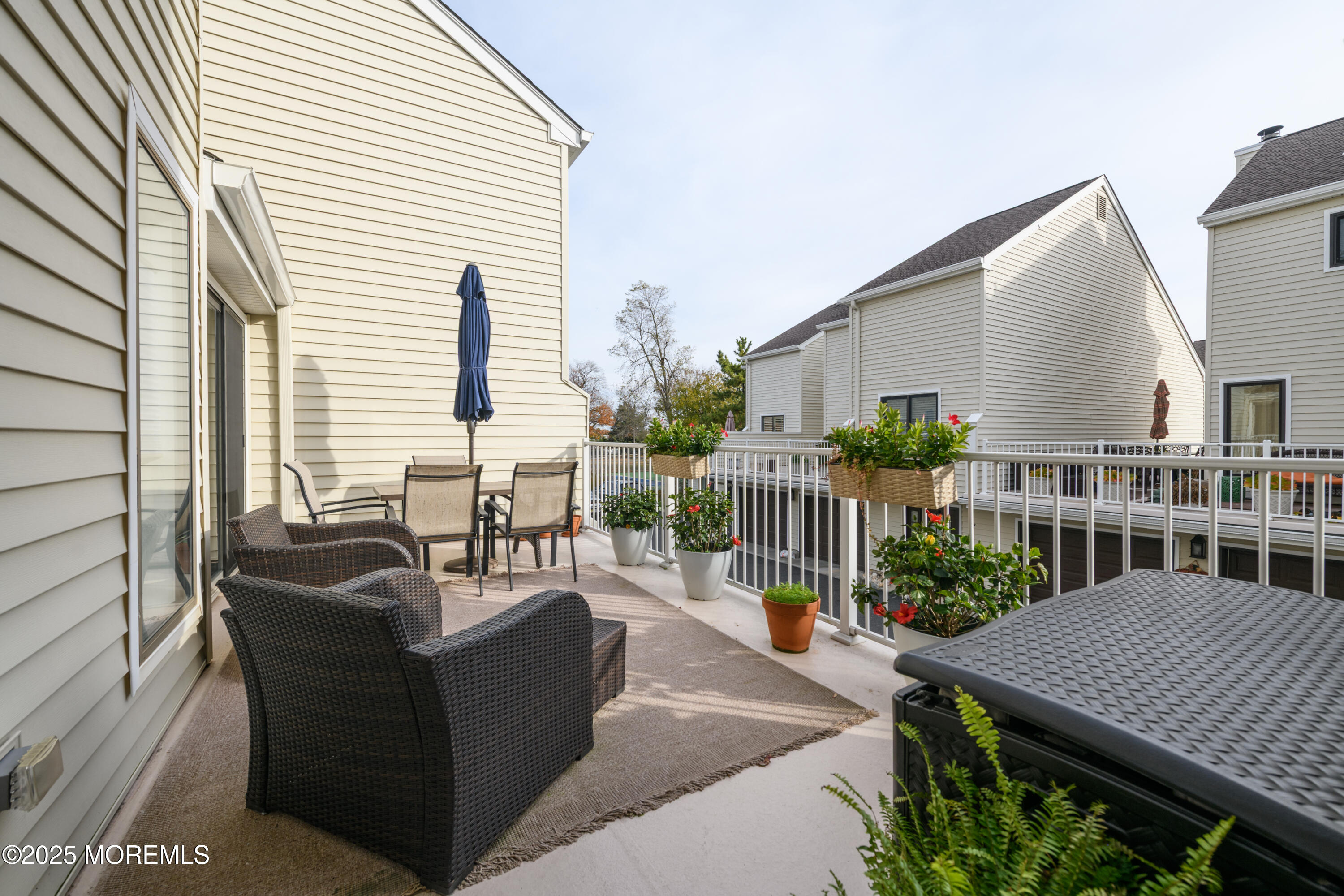 580 Patten Avenue, Unit 31 Long Branch, NJ 07740 - Photo 10 of 30 a balcony with furniture and wooden floor