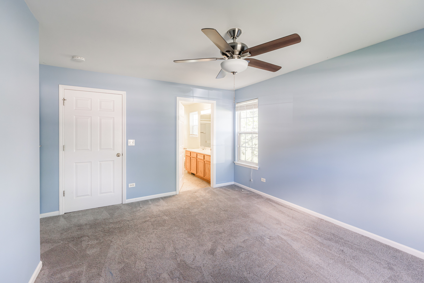 1202 North Red Oak Circle, Unit 2 Round Lake Beach, IL 60073 - Photo 12 of 19 a view of a livingroom with a ceiling fan and window
