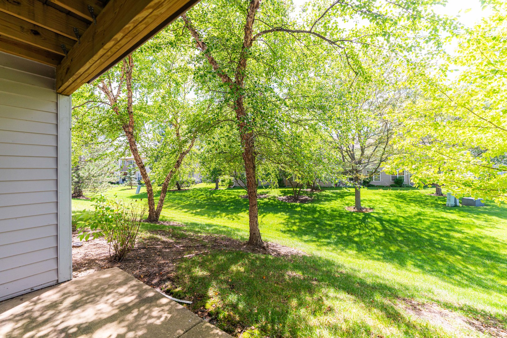 1202 North Red Oak Circle, Unit 2 Round Lake Beach, IL 60073 - Photo 19 of 19 a view of a yard with a tree