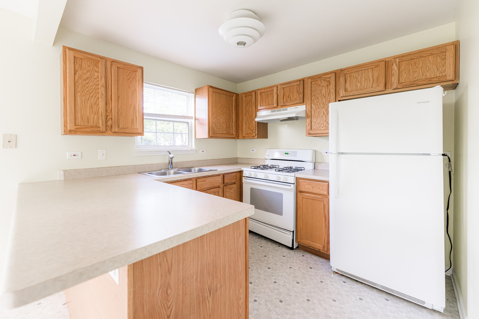 1202 North Red Oak Circle, Unit 2 Round Lake Beach, IL 60073 - Photo 4 of 19 a kitchen with white cabinets and white appliances
