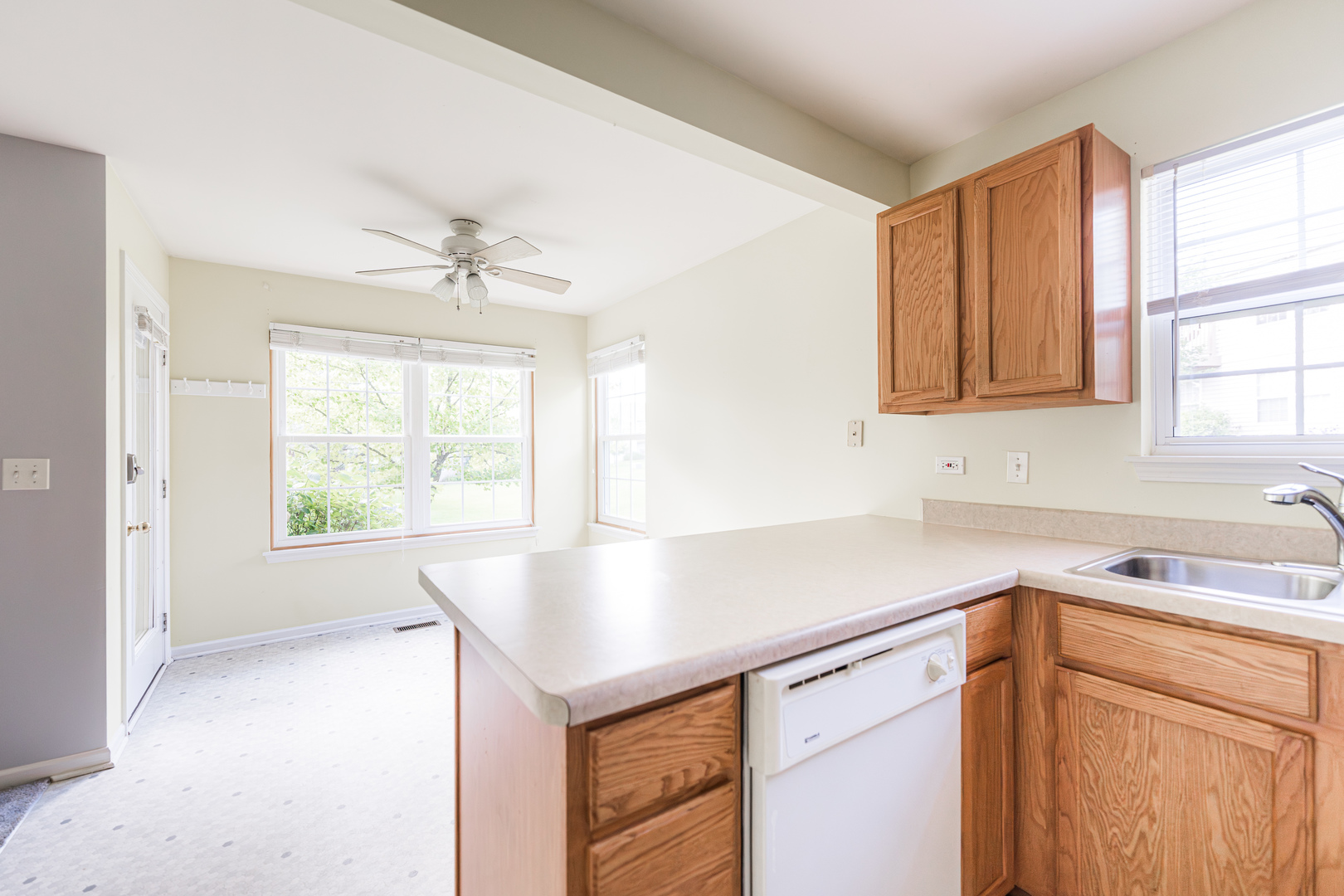 1202 North Red Oak Circle, Unit 2 Round Lake Beach, IL 60073 - Photo 6 of 19 a kitchen with a sink cabinets and window