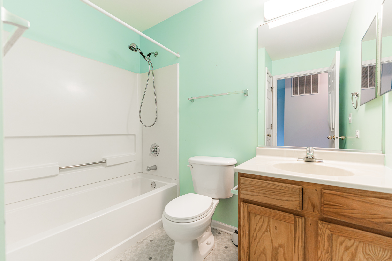 1202 North Red Oak Circle, Unit 2 Round Lake Beach, IL 60073 - Photo 9 of 19 a bathroom with a sink toilet vanity and shower