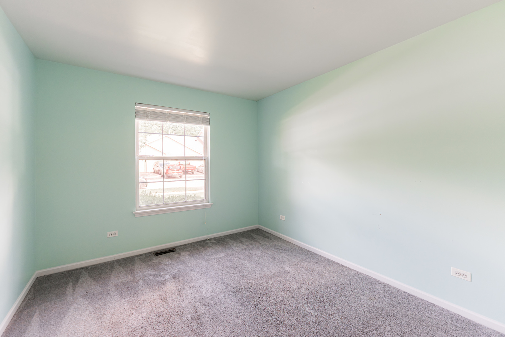 1202 North Red Oak Circle, Unit 2 Round Lake Beach, IL 60073 - Photo 10 of 19 an empty room with a window