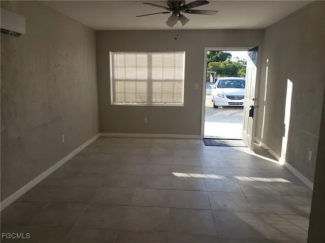 a view of a livingroom with a ceiling fan and window