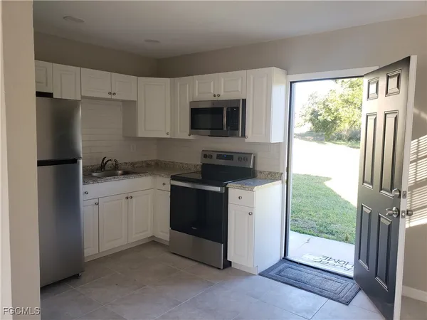 a kitchen with a refrigerator stove and sink