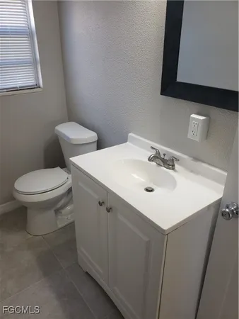 a white sink sitting next to a white toilet