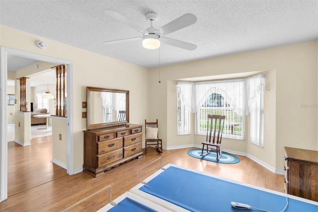 9058 Arundle Place New Port Richey, FL 34655 - Photo 18 of 59 a living room with furniture large window and wooden floor