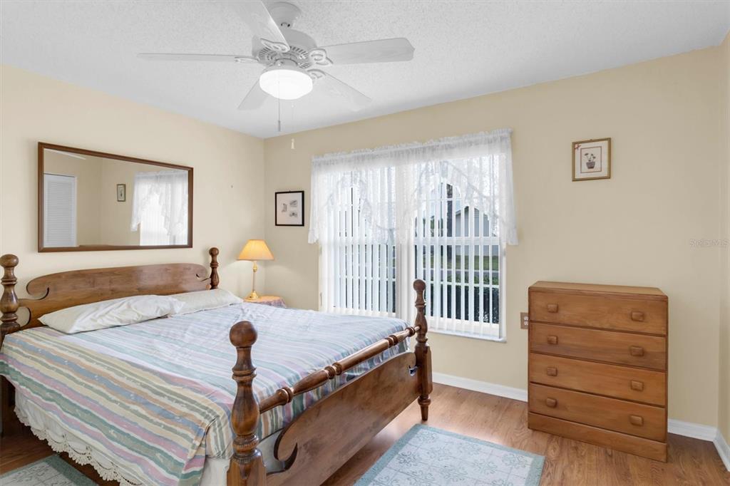 9058 Arundle Place New Port Richey, FL 34655 - Photo 21 of 59 a bed room with a bed and a dresser