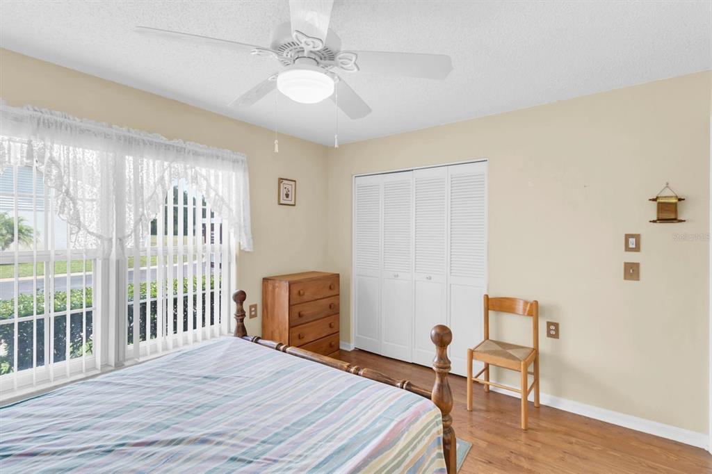 9058 Arundle Place New Port Richey, FL 34655 - Photo 22 of 59 a bedroom with a bed and a table
