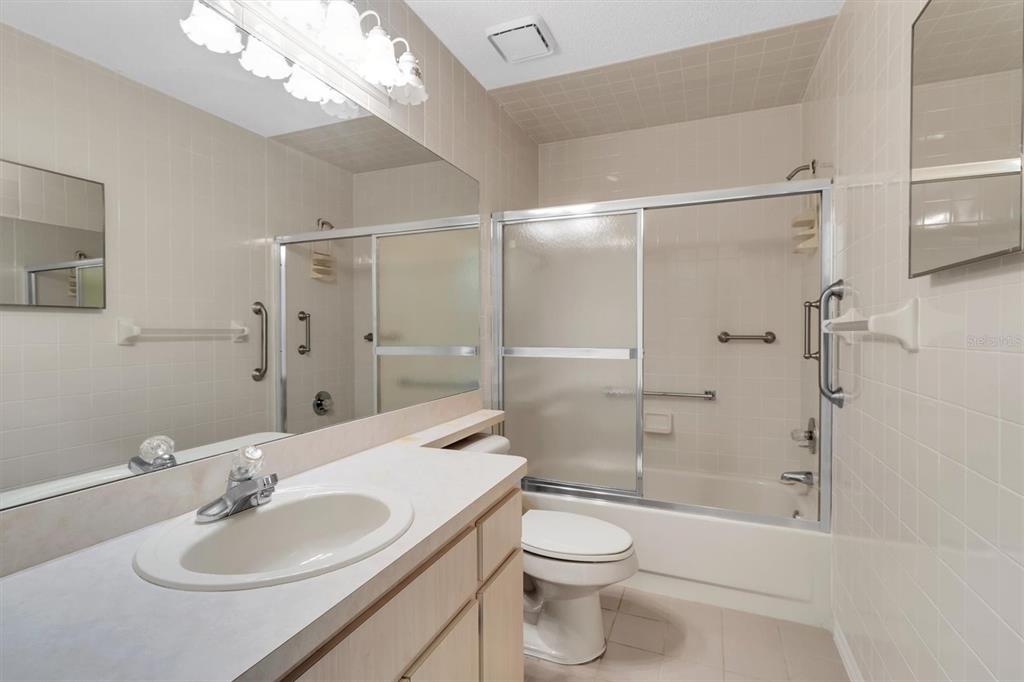 9058 Arundle Place New Port Richey, FL 34655 - Photo 23 of 59 a bathroom with a sink toilet and shower