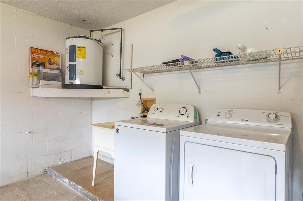 9058 Arundle Place New Port Richey, FL 34655 - Photo 24 of 59 a utility room with dryer and washer