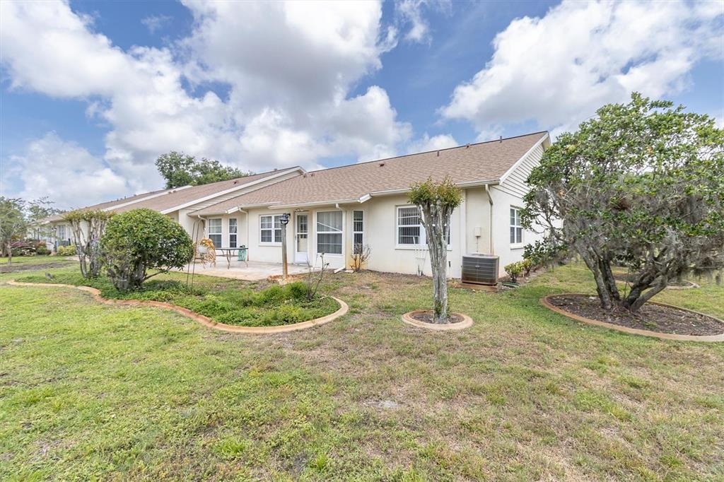 9058 Arundle Place New Port Richey, FL 34655 - Photo 26 of 59 a view of a house with backyard and trees
