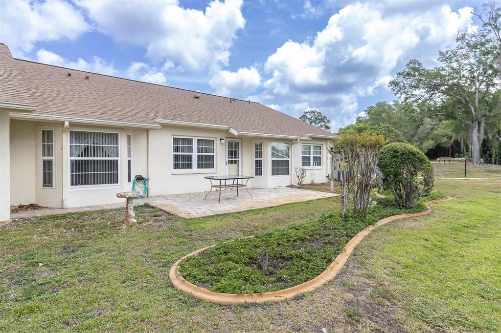 9058 Arundle Place New Port Richey, FL 34655 - Photo 27 of 59 a view of a house with backyard and sitting area