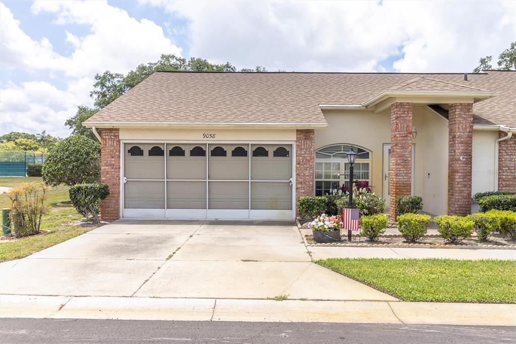 9058 Arundle Place New Port Richey, FL 34655 - Photo 31 of 59 a front view of a house with a yard