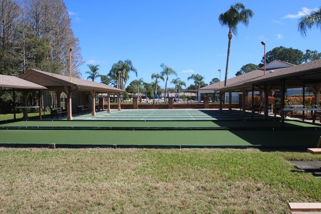 9058 Arundle Place New Port Richey, FL 34655 - Photo 45 of 59 a front view of a building with a garden and trees