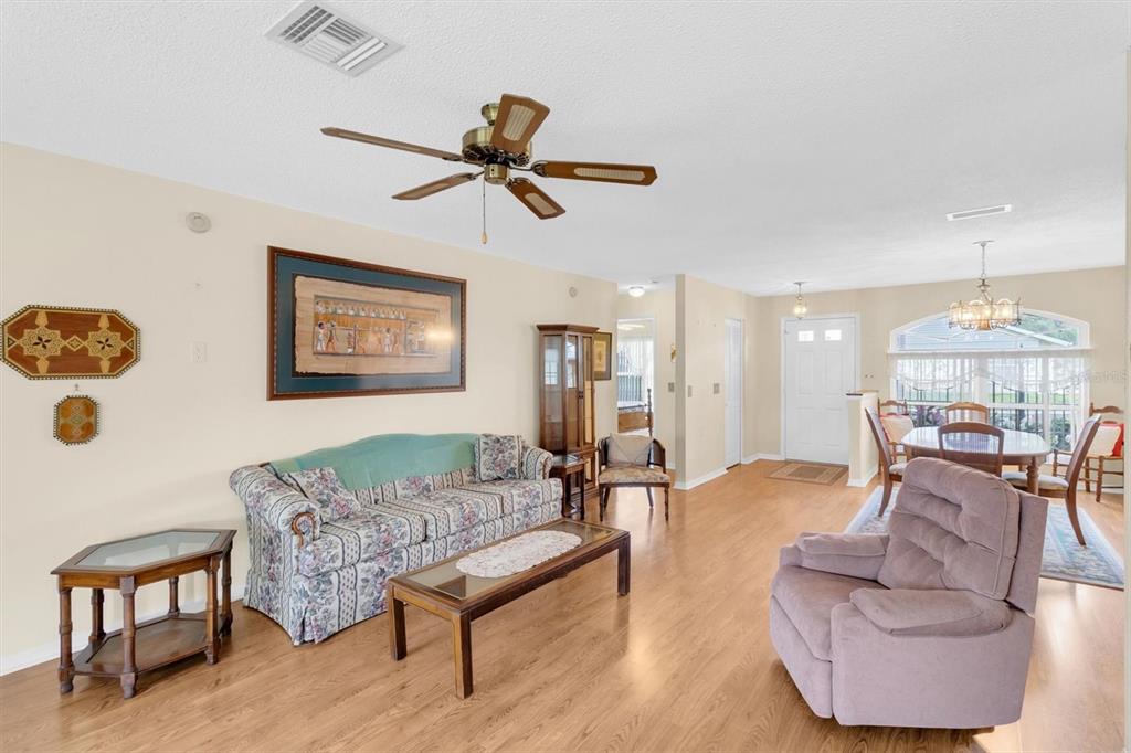 9058 Arundle Place New Port Richey, FL 34655 - Photo 7 of 59 a living room with furniture and a chandelier