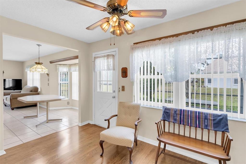 9058 Arundle Place New Port Richey, FL 34655 - Photo 8 of 59 a living room with furniture and wooden floor