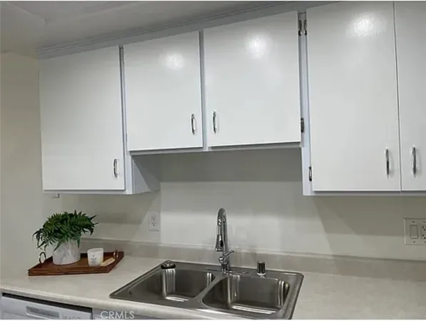 a kitchen with a sink and cabinets