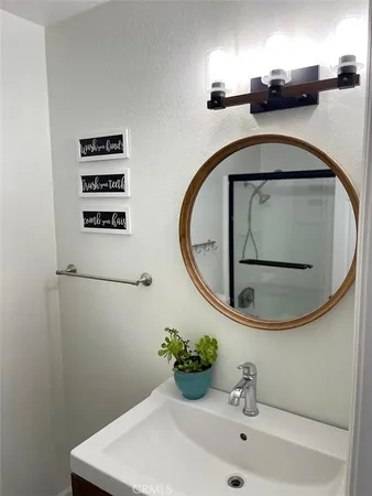 a bathroom with a sink and mirror
