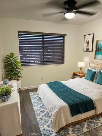 a bedroom with a bed and a large window